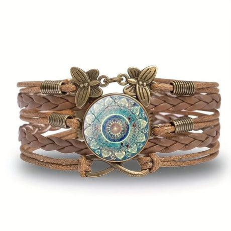 Brown leather bracelet with decorative metal elements and a circular medallion on a white background