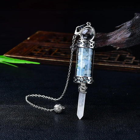 Crystal pendant with chain on a dark background