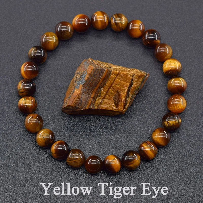 Yellow tiger eye bracelet with a piece of tiger eye stone on a gray background
