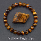 Yellow tiger eye bracelet with a piece of tiger eye stone on a gray background