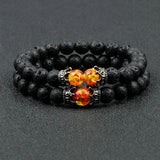 Black beaded bracelet with orange gemstones on a dark gray background