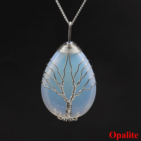 Opalite pendant with tree design on a black background