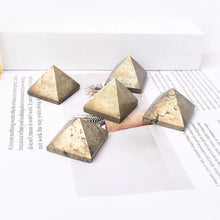 Pyramidal crystals on a white surface with text