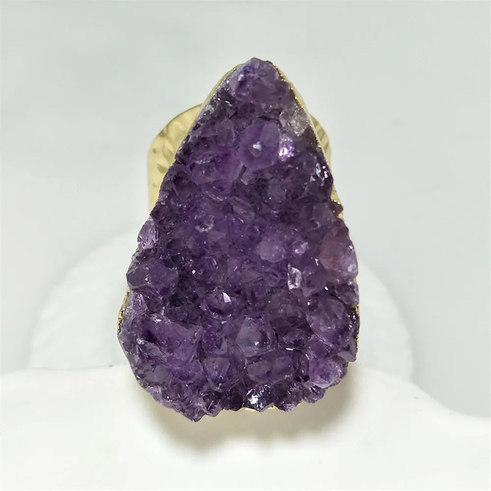 Purple crystal ring with gold band on a white background