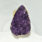 Purple crystal ring with gold band on a white background