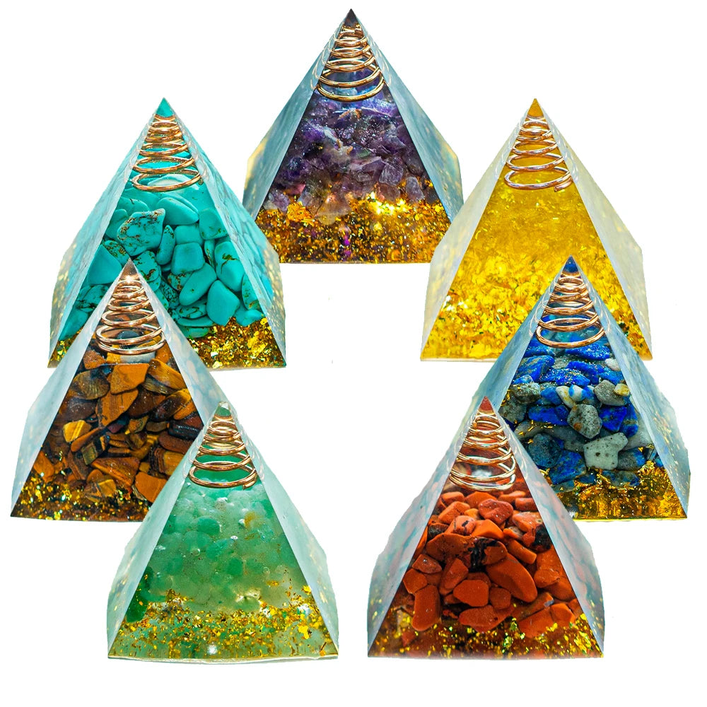 Set of five pyramid-shaped crystal orgone energy generators with colorful stones inside on a white background.