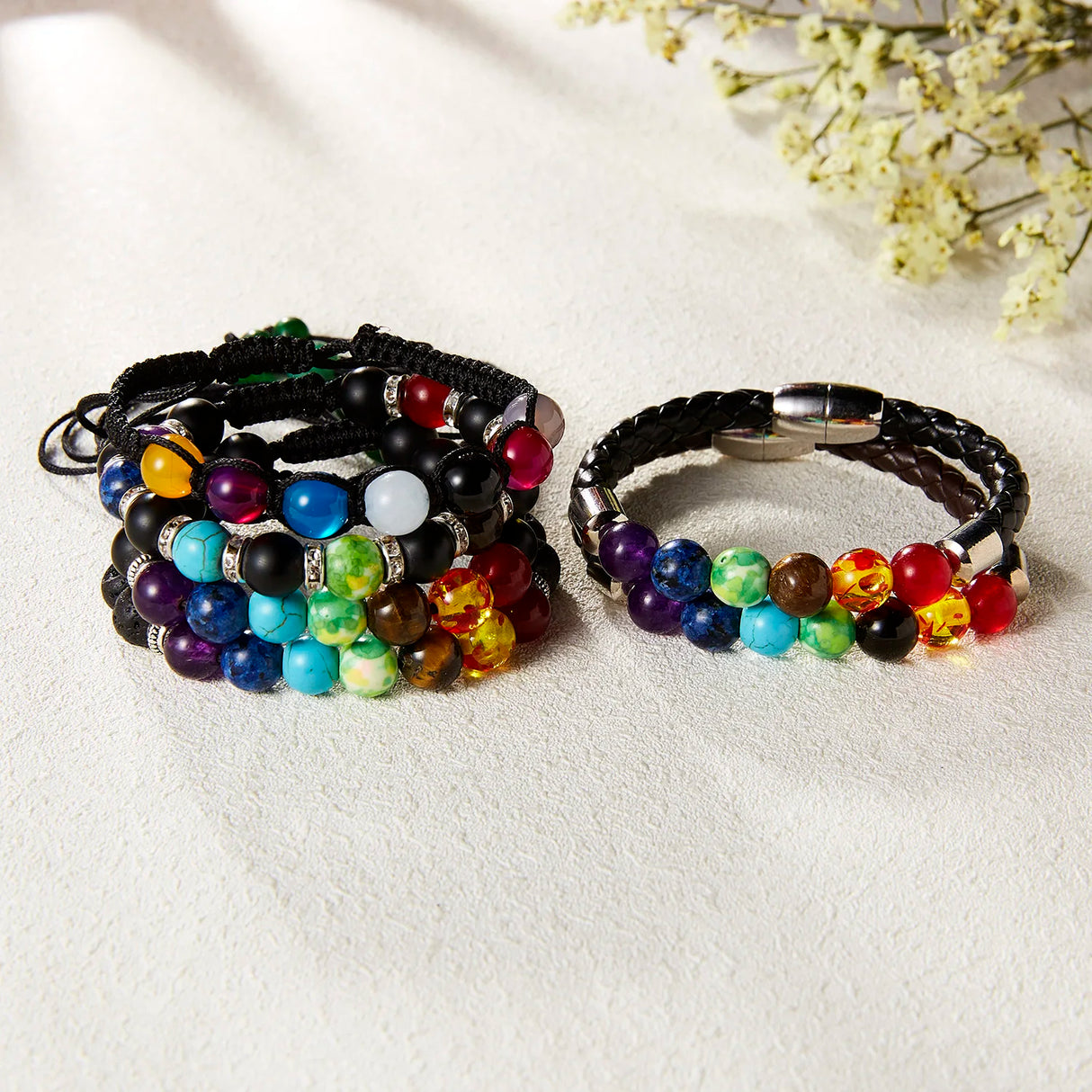 Set of colorful beaded bracelets on a light background
