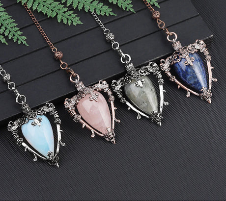 Four gemstone pendants on chains with a brand logo in the corner.