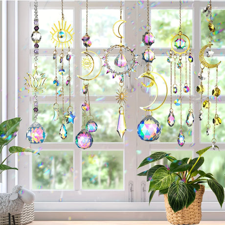 Decorative crystal sun catchers hanging in front of a window with plants on either side.