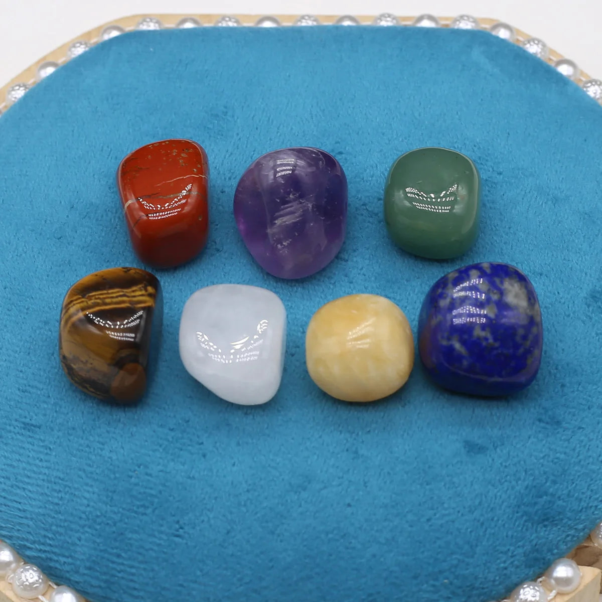 Set of colorful tumbled stones on a blue cloth