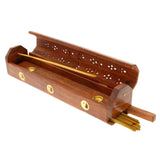 Wooden incense holder with gold accents on a white background