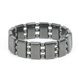 Silver bracelet with rectangular links and beads on a white background