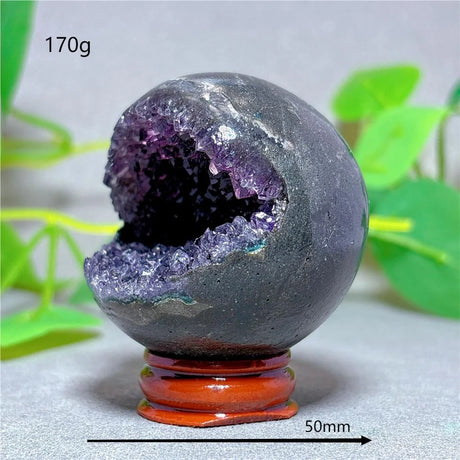 Geode crystal sphere with purple interior on a stand, labeled with weight and size.