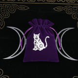 Purple drawstring bag with a white cat design on a black background with moon symbols.