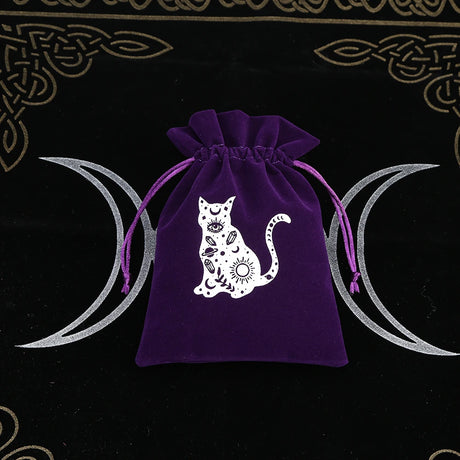 Purple drawstring bag with a white cat design on a black background with moon symbols.