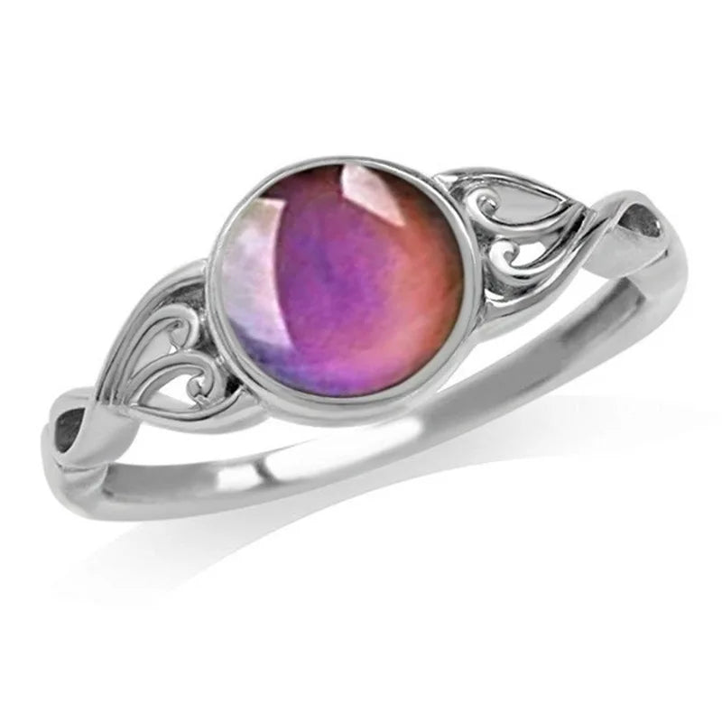 Silver ring with a purple gemstone on a white background