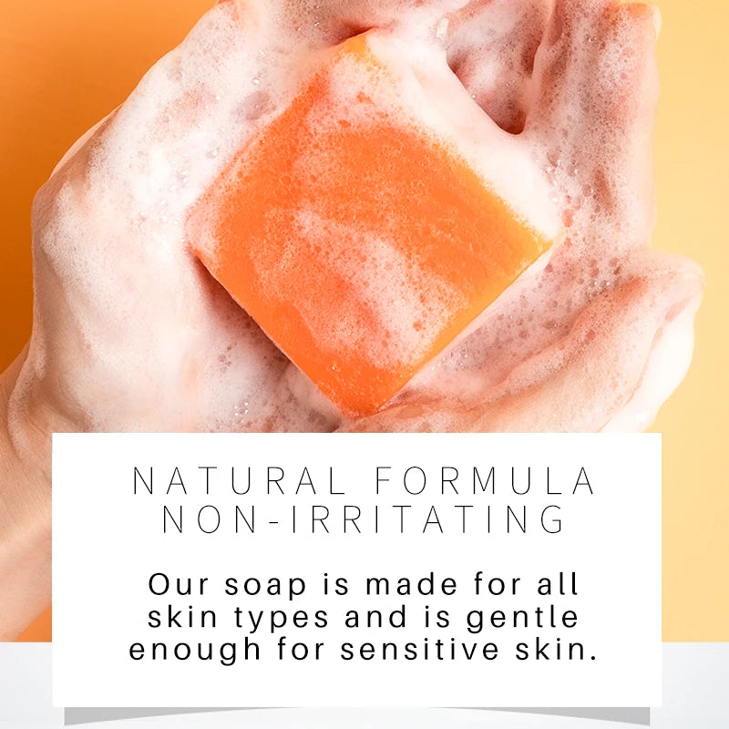 Bar of soap with a block of orange soap on top, against a yellow background.