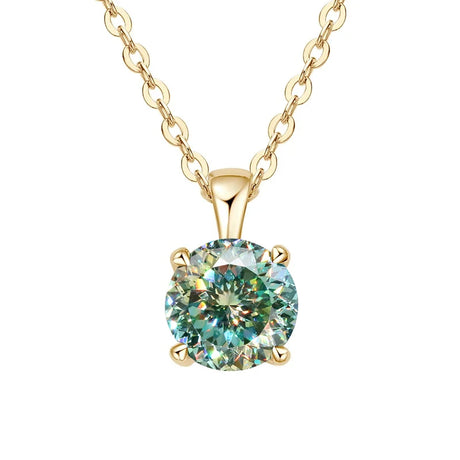 Gold necklace with a green gemstone pendant on a white background