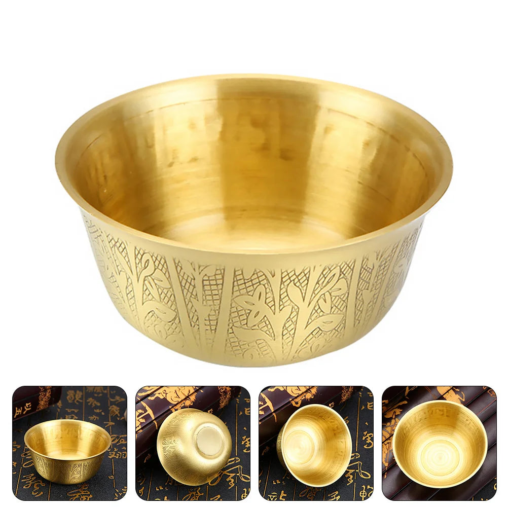Gold bowl with engraved patterns on a white background