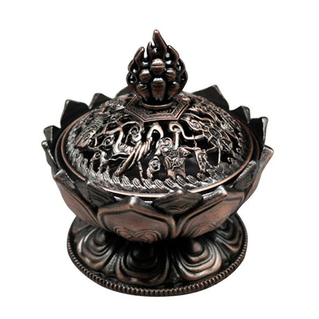 Decorative bronze incense burner with intricate designs on a white background