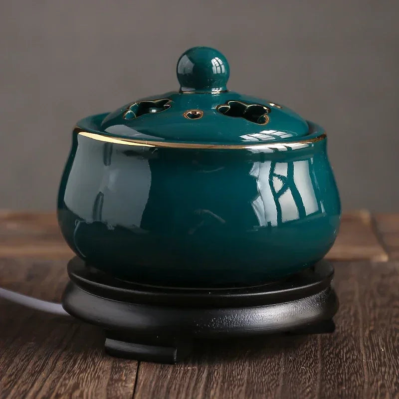 Teal ceramic incense burner on a wooden surface with a neutral background