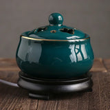 Teal ceramic incense burner on a wooden surface with a neutral background