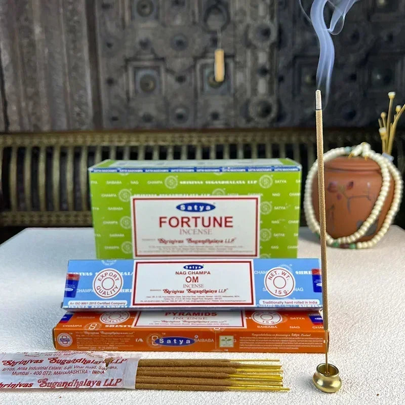 Satya Nag Champa Incense Collection boxes with lit stick