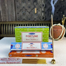 Satya India Aromatherapy Incense Sticks boxes with lit stick