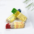 Three bundles of incense sticks with colorful labels on a white background