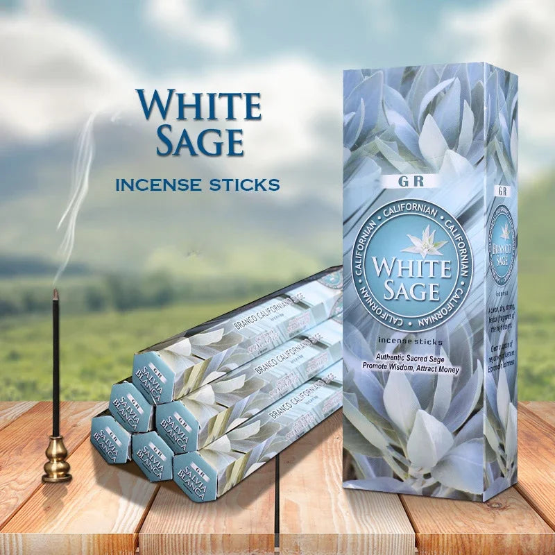 White Sage incense sticks with packaging on a wooden surface and blurred natural background