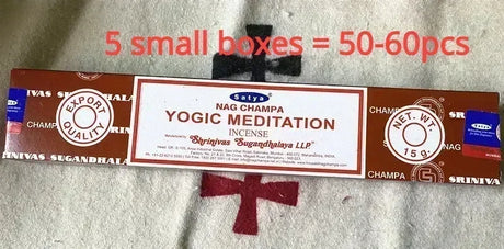 Yogic Meditation incense packaging with text indicating quantity on a textured surface.