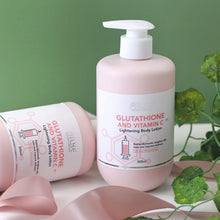 AILKE Vitamin C & Glutathione Brightening Lotion 500ml bottles on green background with plants.
