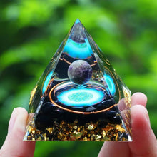 Amethyst Orgone Energy Pyramid with glowing blue center stone detail.