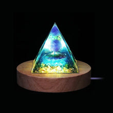 Amethyst Orgone Energy Pyramid glowing on wooden LED base for meditation and healing.