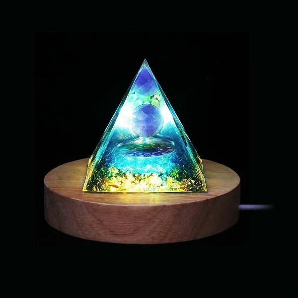 Amethyst Orgone Energy Pyramid glowing on wooden LED base for meditation and healing.