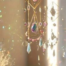 Amethyst suncatcher with golden hanging chain for window decoration, light reflection, and crystal-inspired interior decor.