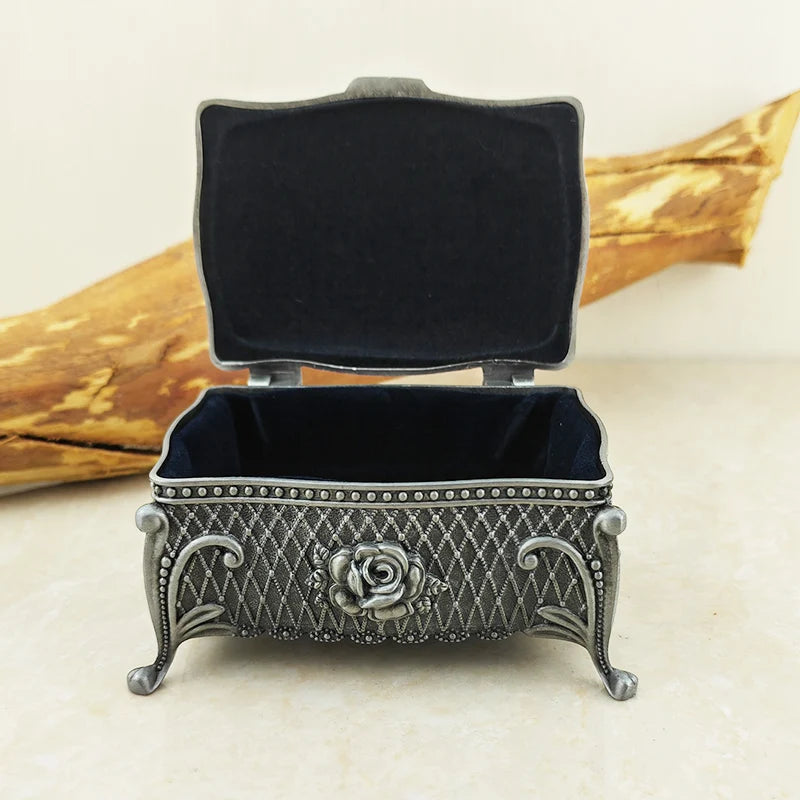 Antique-style metal flower trinket box for holding rings, necklaces, and cherished keepsakes.