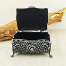 Antique-style metal flower trinket box for holding rings, necklaces, and cherished keepsakes.