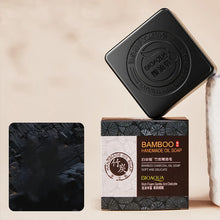 Bamboo Charcoal and Essential Oil Soap bar with dark packaging and product details.