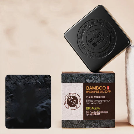 Bamboo Charcoal and Essential Oil Soap bar with dark packaging and product details.