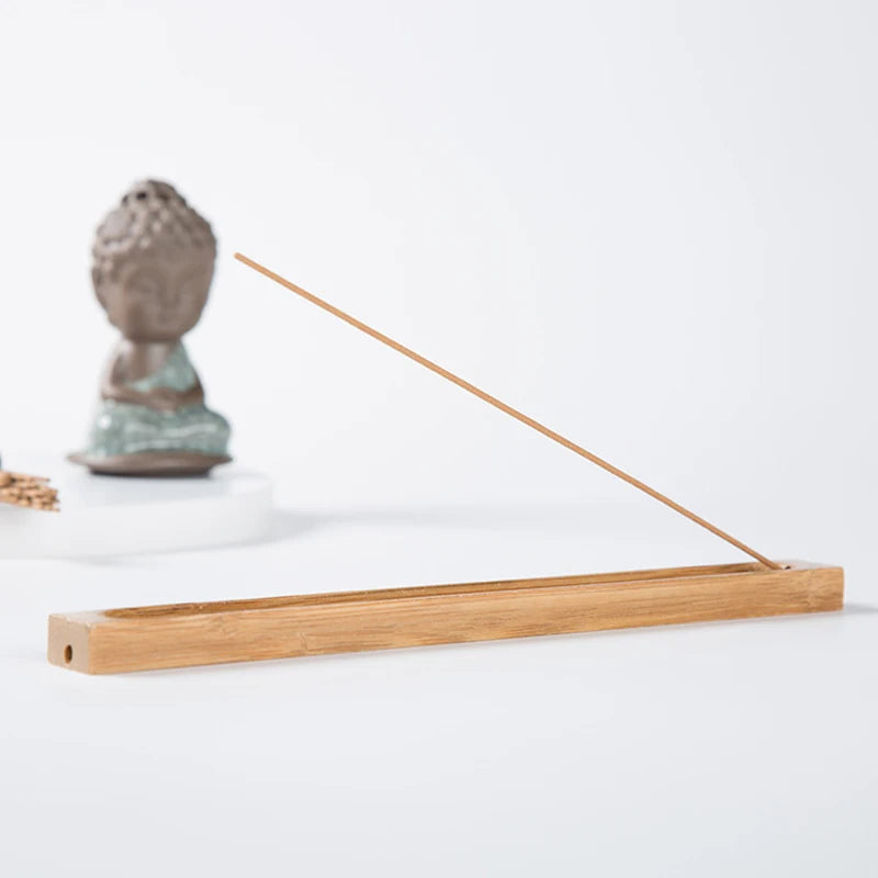 Bamboo incense holder for meditation and mindfulness practice, designed to hold incense sticks neatly while catching ash.