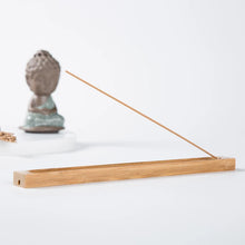 Bamboo incense holder for meditation and mindfulness practice, designed to hold incense sticks neatly while catching ash.