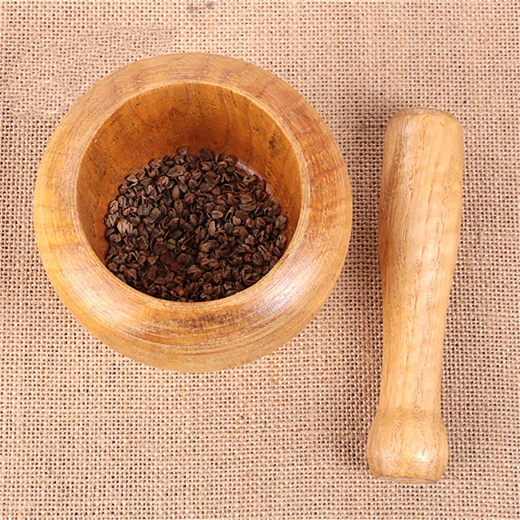 Bamboo mortar and pestle set for crushing garlic, herbs, and fresh spices for meal preparation.