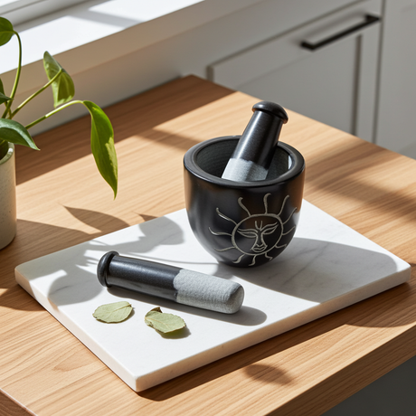 Black soapstone Sun Carved mortar and pestle bowl set for crushing spices, seeds, and kitchen ingredients.