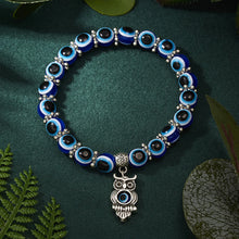 Blue evil eye bracelet with charms for layering with jewelry, spiritual protection symbolism, and casual wear.