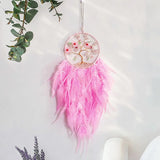 Boho pink Tree of Life dream catcher hanging for wall decoration, meditation space styling, and cozy room decor.