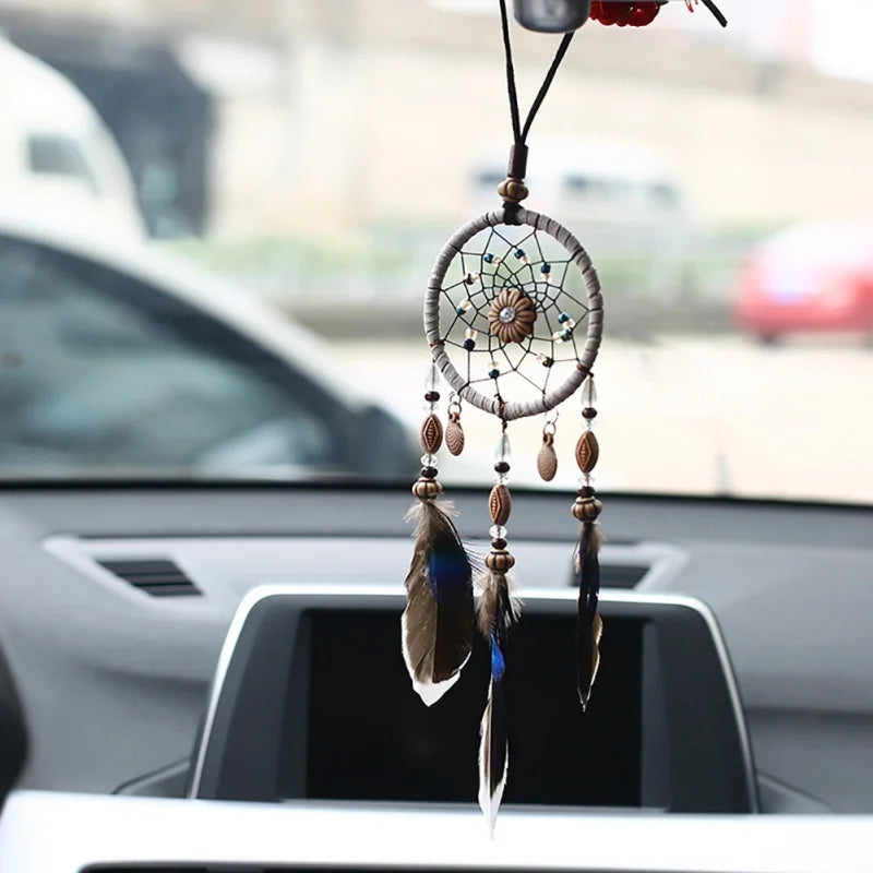 Car dream catcher hanging ornament with natural feathers for vehicle interior decor, positive energy, and travel protection.