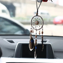 Car dream catcher hanging ornament with natural feathers for vehicle interior decor, positive energy, and travel protection.