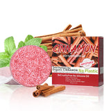 Cinnamomum Herbal Solid Shampoo Bar next to cinnamon sticks and mint leaves on white background.