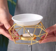 Copper essential oil warmer for home use with tealight holder for diffusing fragrance and creating a calming atmosphere.